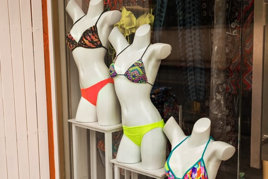 Women's swimsuits on mannequins for sale at a seaside shop. photo