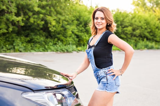 Smiling woman with her car photo