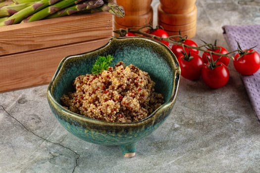 A bowl of quinoa with vegetables and tomatoes photo