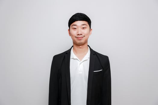Cheerful asian man black suit happy smile isolate photo