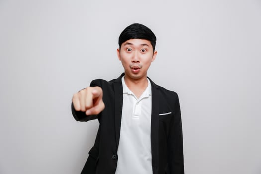Asian business man point finger choose you isolated photo
