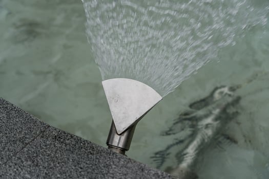 Fountain nozzle disperses water, fountain, water close-up photo