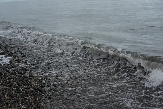 Outgoing wave on a stone beach in Batumi photo