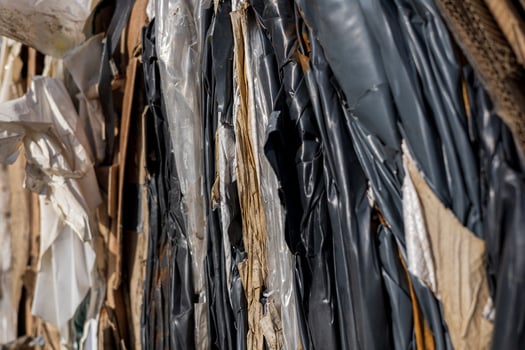 Close-up view of layers of plastic waste and debris in a landfill, emphasizing urgent concerns in ecological management and recycling efforts photo