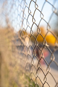Selective focus of chain-link fencing, formed by the interlocking wires. photo