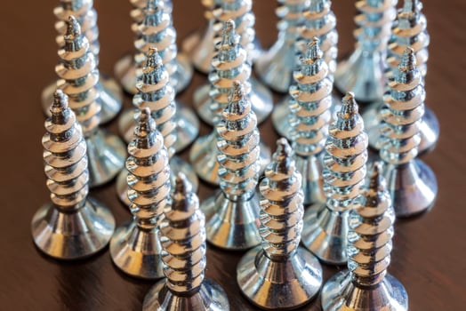 Close up of screws on a table. Advertising photo