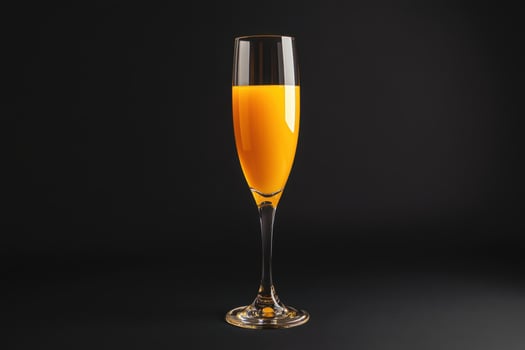 orange juice in a glass on a black background photo