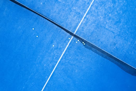 Padel Balls on a Vibrant Blue Court, Ready for a Game or Training photo