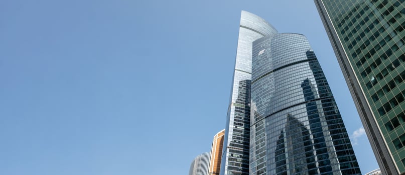Modern Skyscrapers Reflect Sunlight Against a Clear Blue Sky in Moscows Bustling Cityscape photo