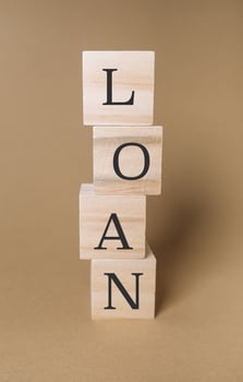Stack of wooden blocks with the word loan written on them photo