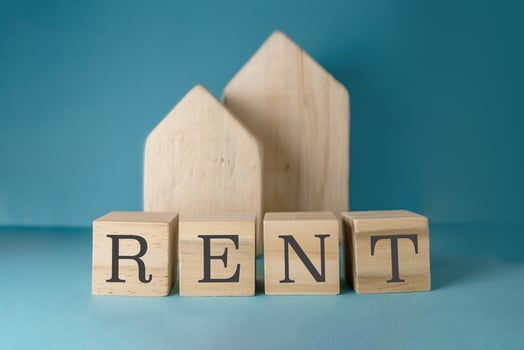 Wooden block with the word rent written on it photo