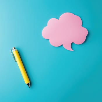 Creative workspace with a pen and speech bubble photo