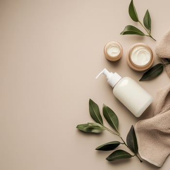 Cream containers and towel arranged on a surface photo