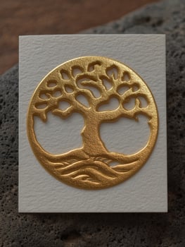 Golden tree of life symbol on textured paper photo