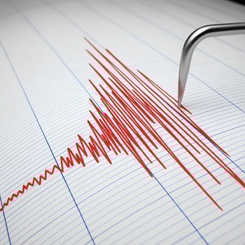 Earthquake recording seismograph. The needle draws red lines on the paper indicating strong tremors. photo
