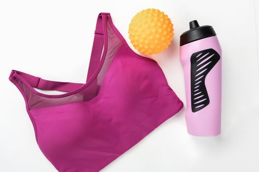 Concept of sports lifestyle. Flat lay of sports top bra and drinking bottle for water. photo