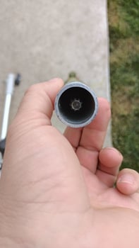 A Detailed CloseUp of a Pipe Opening Captured with the Help of a Hand for Analysis photo