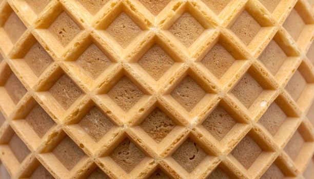 symmetrical waffle cone grid texture macro, crisp square pattern of baked dessert surface for food background or packaging design photo