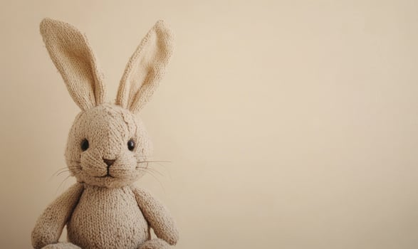 a stuffed rabbit is sitting on a wooden table photo