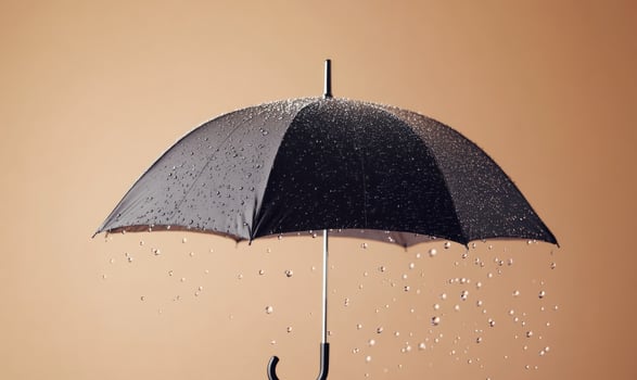 A black umbrella is opened and raining on a wall photo