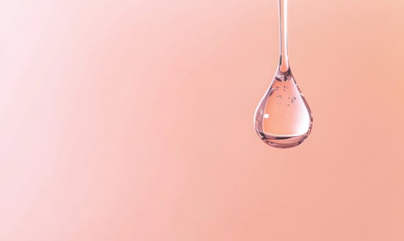 A drop of water hangs from a faucet photo