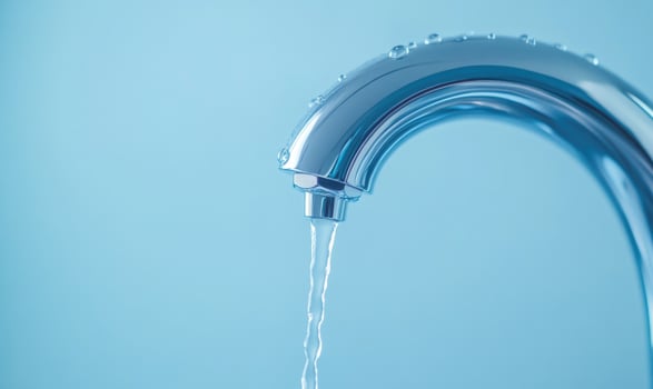 A silver faucet with water dripping from it photo