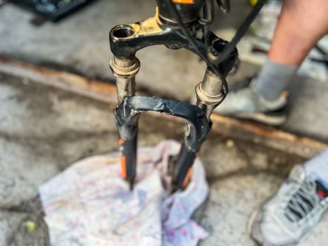 Mechanic repairing damaged bicycle fork in workshop photo