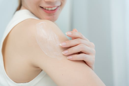 Beautiful Asian woman smile use cream for good skin. healthy woman apply cream for body. Advertisement for skin cream, anti-wrinkle, baby face, whitening, tighten pores serum photo