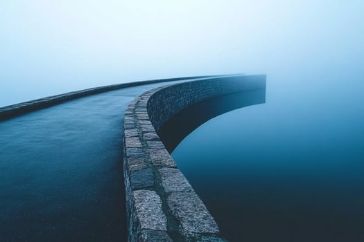 A long bridge with fog on the water photo