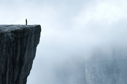 A man standing on the edge of a cliff photo