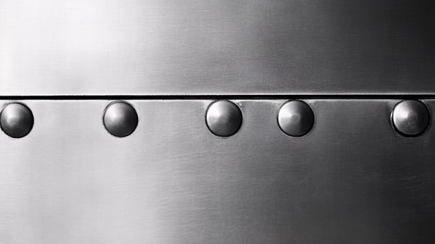 Brushed Stainless Steel Plate Sheet with Rivets Showing Distinctive Texture photo