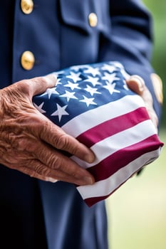 Veteran holding folded american flag, symbol of service and sacrifice photo