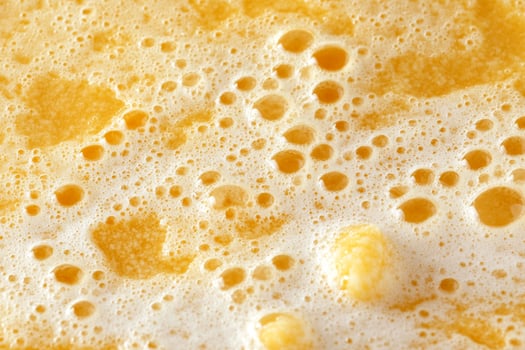A close up of a foam of orange juice photo