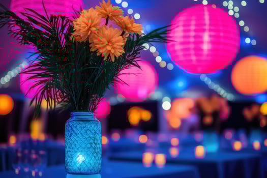 Yellow flowers in blue vase illuminating a party in the background photo