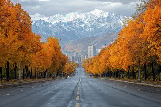 Empty road leading to mountains flanked by autumn trees photo