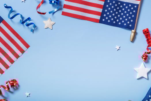 Festive decorations for USA Independence Day with flags, stars and ribbons on blue backdrop photo