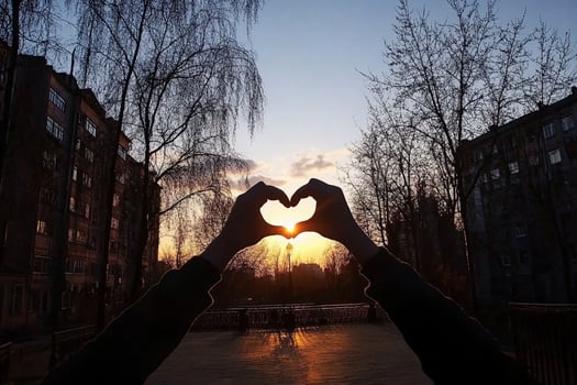A person making a heart shape with their hands photo