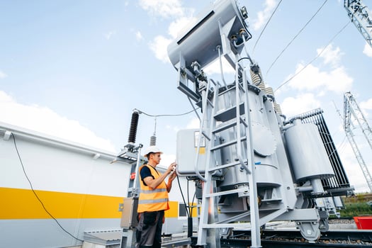 dult electrical engineer inspect the electrical systems at the equipment control cabinet. Installation of modern electrical station. photo
