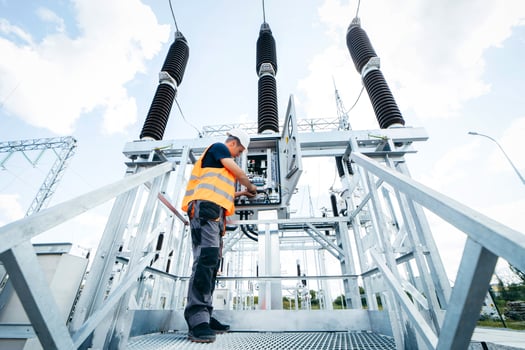 dult electrical engineer inspect the electrical systems at the equipment control cabinet. Installation of modern electrical station photo