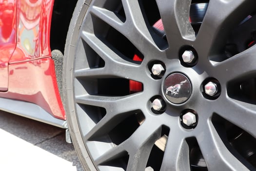 09.3.2025 Moldova A Black Alloy Wheel on a Red Sports Car, showcasing modern design and performance excellence photo