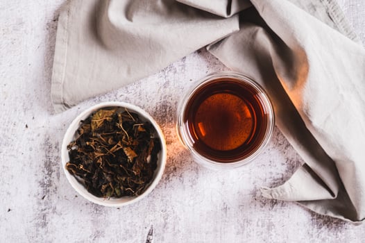 Close up of Earl Grey tea with bergamot in a cup on table top view photo