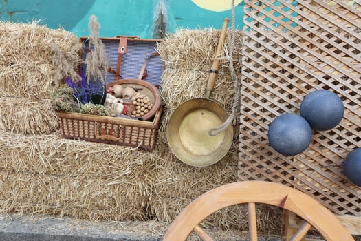 A Rustic Farm Display Featuring Straw Bales Alongside a Collection of Vintage Items and Decorations photo