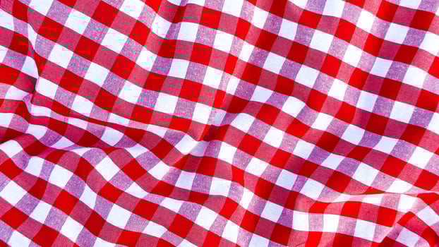 Red and white checkered fabric texture with wavy pattern close up photo