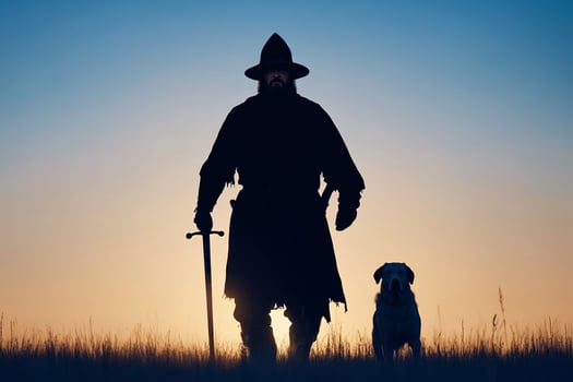 Silhouette of a man with a sword and dog in the field at sunset photo