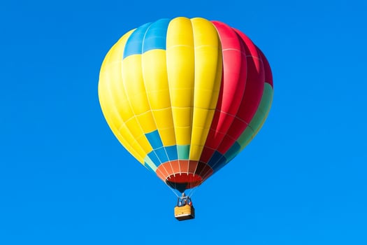 A colorful hot air balloon flying in the blue sky photo