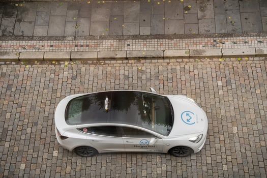 Bergen, Norway - July 7, 2024. Tesla taxi from NorgesTaxi on cobblestone street top view photo