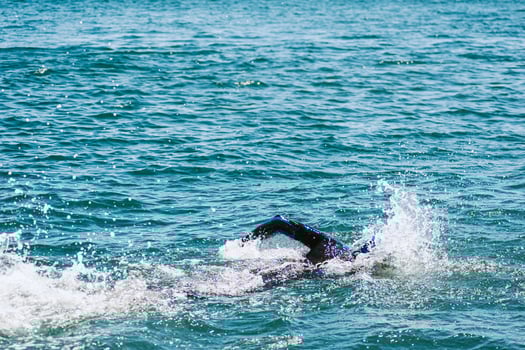 An Athlete Competing in an Open Water Swimming Race in the Sea photo