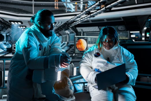 Teamworking astronauts use tablet to ensure safe operation during long distance space travel to Mars. Orbital station crew monitors system stability during cosmic journey to red planets photo