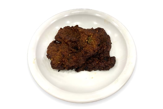 Flavourful and juicy beef chappal kebab in a white plate beautifully isolated on the white background photo