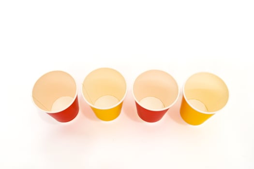 Colorful paper cups in a row for party decorations and food packaging concept photo